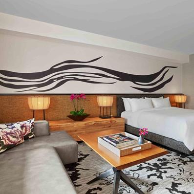 Modern hotel bedroom with beautiful modern rug by Rockwell Group