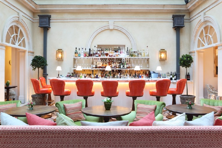 Lime Wood, New Forest Orange stools at the Terrace bar by Martin Brudnizki Design Studio