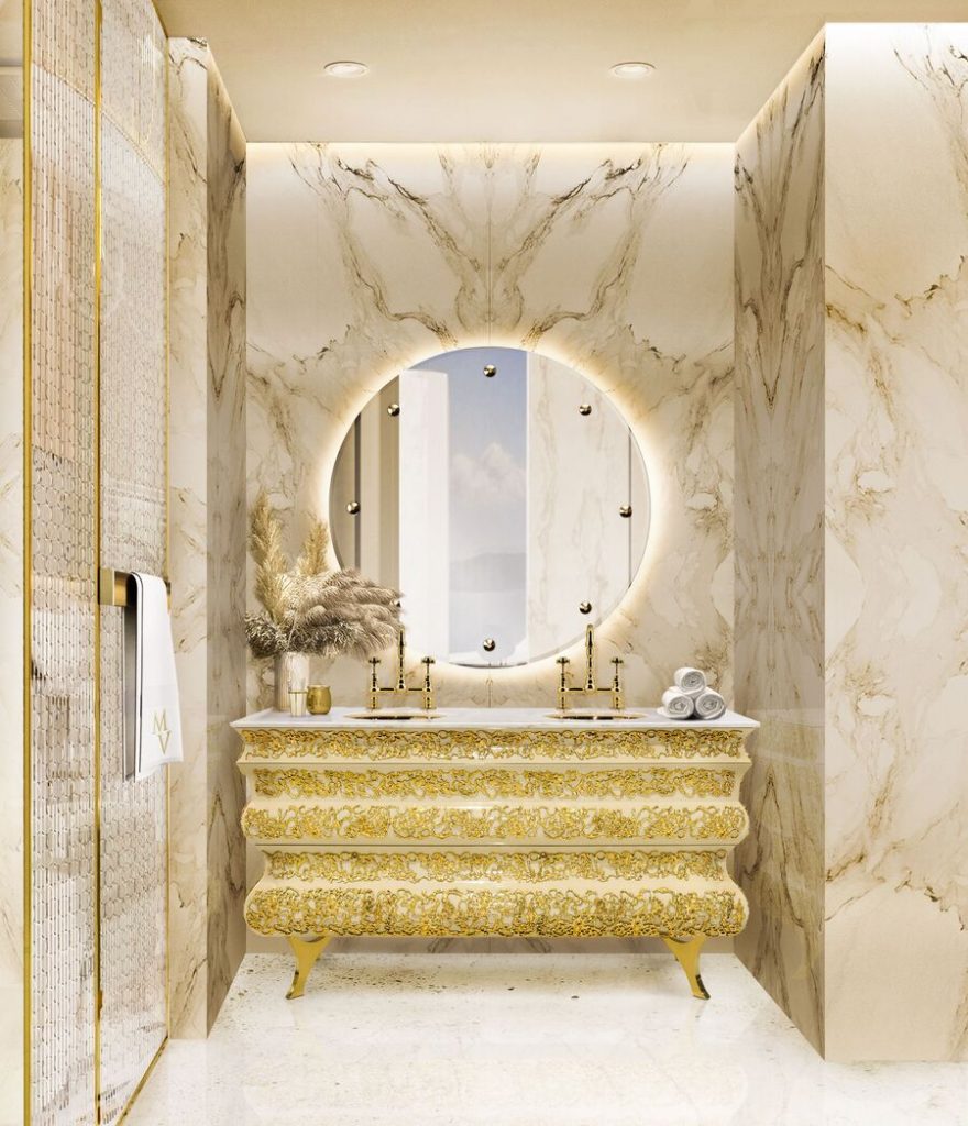 marble bathroom with a golden bashbasin in big circular mirron