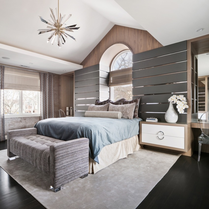 A luxurious room with wooden material and modern brass and gold chandelier